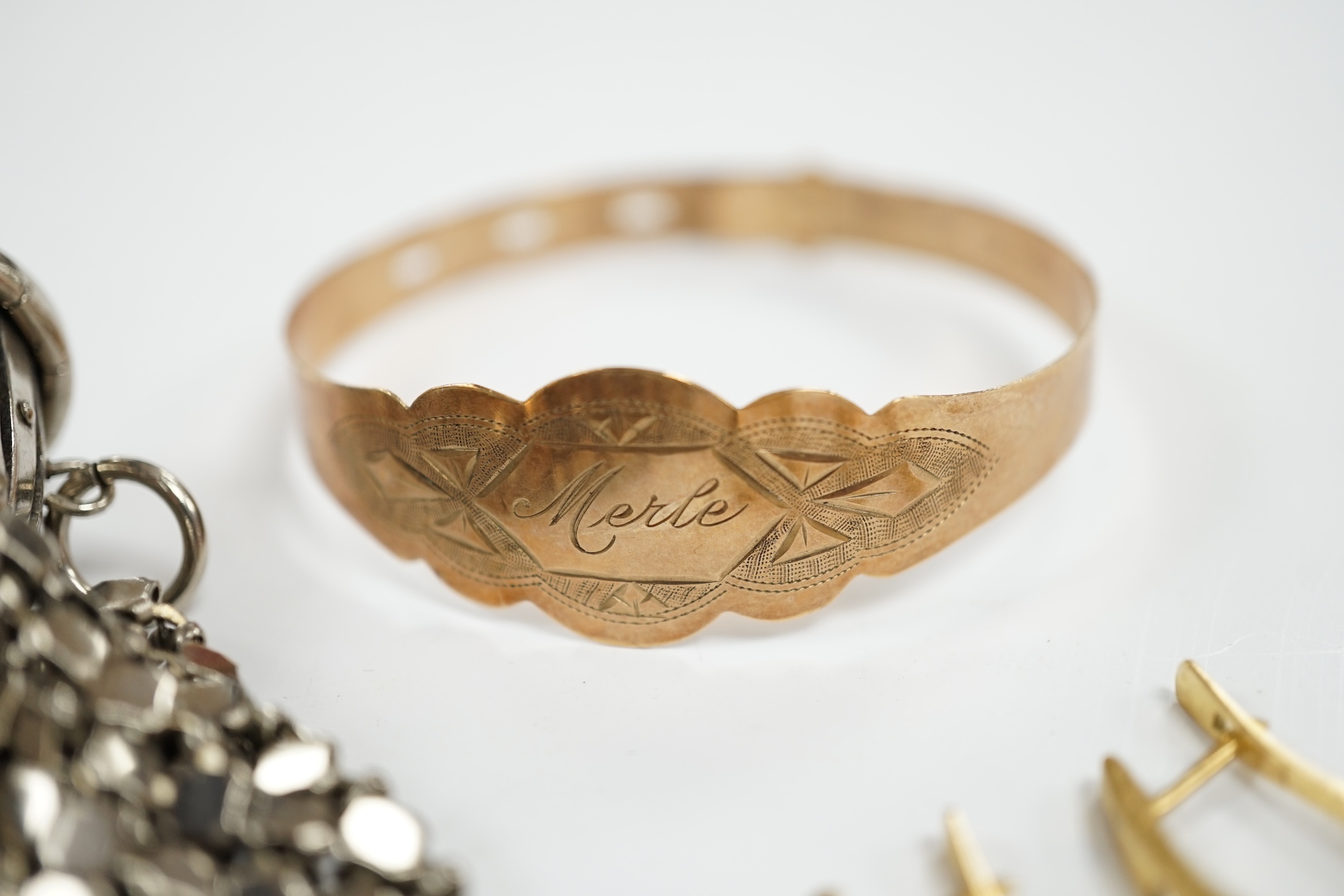 A 9ct gold bracelet inscribed ‘Merle’, a pair of 14k and diamond chip set earrings and an expanding metal purse. Condition - fair